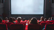 © Badisaba - A movie theater showcases a large  empty screen with audience