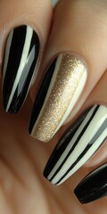 Wall Mural - Close-up of stylish nails with black, white, and gold stripes.