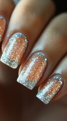 Wall Mural - Close-up of elegantly manicured nails with a light peach and silver glitter design.