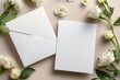 © SEUNGJIN - Blank wedding invitation card mockup with envelope and white flowers, front and back sides, mockup with copy space