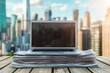 © PD - A laptop rests on a pile of newspapers on a wooden table, overlooking a bustling city skyline bathed in natural light during the day.