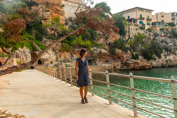 Wall Mural - Tourist walking on the seaside promenade in puerto cristo, mallorca