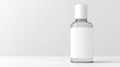 © Sergei - top-down view of minimalist nail polish bottle with blank white label placed elegantly on plain white surface
