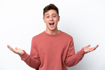 Wall Mural - Young handsome Brazilian man isolated on white background with shocked facial expression