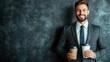 © CreativeLoom - Smiling businessman holding coffee cups against a textured wall. leadership concept