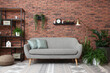 © New Africa - Modern living room interior. Comfortable sofa near brick wall