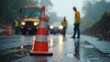 © Andrey - Construction workers managing road repairs on a rainy urban street in the evening fog