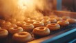 © Chayada - Freshly Fried Donuts on Conveyor with Steam Rising in Warm Bakery Light