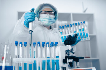 Aufkleber - A scientist is currently engaged in research and working diligently within a stateoftheart laboratory, utilizing various test tubes and equipment to conduct precise scientific experiments