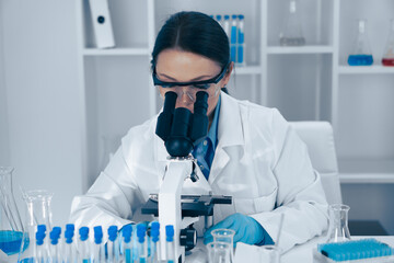 Aufkleber - A scientist is diligently analyzing various samples under a highpowered microscope in a laboratory setting, showcasing the intricate work involved in modern scientific research and experimentation
