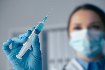 Poster - A healthcare professional is holding a syringe, preparing to administer a vaccination. This important act ensures the health and safety of patients, particularly in clinical and hospital settings