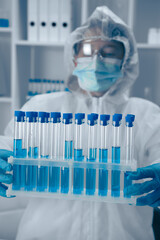 Aufkleber - A Laboratory Technician skillfully analyzing a variety of test tubes filled with vibrant blue solutions, contributing to critical research in the fields of biotechnology and healthcare