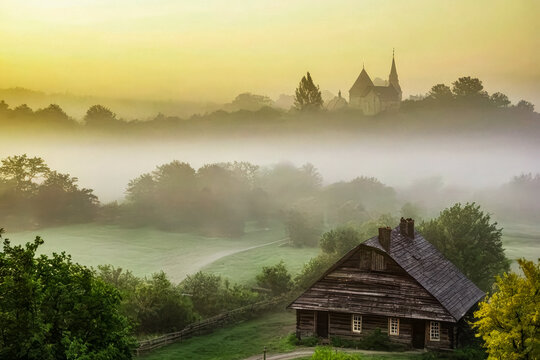 A Foggy Sunrise Over a Serene Village Landscape