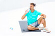 © muse studio - Man takes a break while hydrating after an intense workout session in a bright outdoor setting