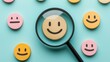 © saichon - A magnifying glass highlights a cheerful smiley face among colorful smiley tokens on a blue background.