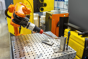 Poster - Robotic soldering equipment. Industrial robot for welding parts. Automatic soldering machine. Robot for welding in enterprise. Soldering machine operates without human intervention.