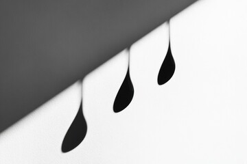 Poster - A close-up image of three water droplets in various shapes, photographed in black and white