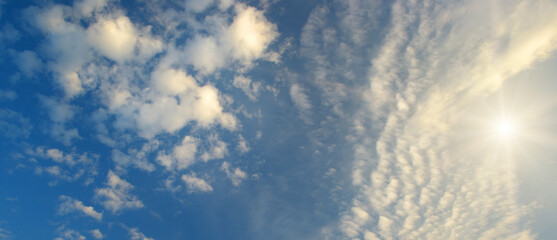 Wall Mural - Blue sky with light, cumulus clouds.