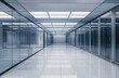 © Саша Федюк - A spacious corridor in a modern data center showcases glass walls and a polished floor, revealing high-tech server racks under bright LED lighting.