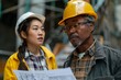 © S photographer - Two construction workers discussing blueprints on a busy job site, wearing safety gear and focused expressions.