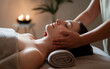 © Pixels Pictures - A serene spa setting where a woman is receiving a facial massage. The therapist's hands gently cradle her face, emphasizing the relaxation of the procedure