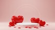 © Habiba - Red heart-shaped balloons placed inside of  a pink podium creating a romantic Valentine's Day theme
