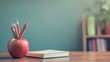 © Ashi - Teacher's desk setup featuring writing materials, book, apple, and blank space for educational content or school-themed background