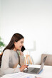 © Fahng - Happy young Asian business woman with a smile using smartphone at the office.