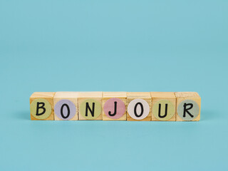 inscription the words bonjour, translate in english is congratulation. arranged on wooden word block