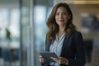 © andyaziz6 - Confident Businesswoman Using Tablet in Modern Office