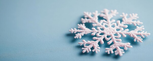 Poster - Snowflake abstract background idea. A delicate snowflake design on a soft blue background, symbolizing winter beauty.