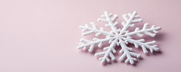Poster - Snowflake abstract background idea. A beautiful white snowflake resting on a soft pink background, showcasing intricate design.