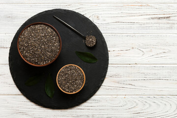 Wall Mural - Chia seeds in bowl and spoon on colored background. Healthy Salvia hispanica in small bowl. Healthy superfood