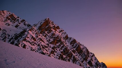 Poster - Snow-capped mountain peaks glow at dawn in a serene winter landscape