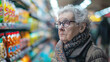 © DP - Elderly woman gazing thoughtfully in a supermarket aisle