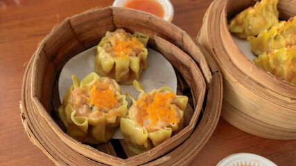 Wall Mural - Shumai or Dimsum steamed in a bamboo steamer bowl. Chinese food menu.