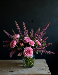 Canvas Print - A vase filled with pink flowers sitting on top of a wooden table