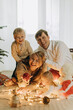 © Westend61 - Happy parents and children with illuminated string light at home