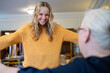 © Westend61 - Excited caregiver with arms outstretched looking at senior woman at retirement community