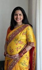 Wall Mural - A woman in a yellow and red sari is smiling