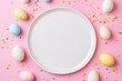 Colorful Easter eggs arranged around a blank white plate on a pink background