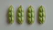 © Bejo Studio - Four open pea pods on a white background.