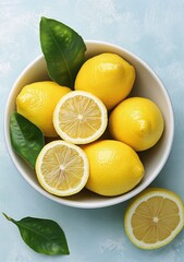 Canvas Print - Freshly sliced lemons arranged in a bowl with green leaves on a marble surface