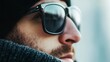 © progressman - a man wearing sunglasses and a hat looks off into the distance with a blurry background