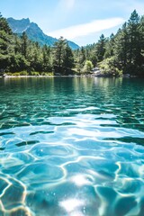 Wall Mural - A beautiful lake with a mountain in the background. The water is clear and calm. The sky is blue and there are trees in the background