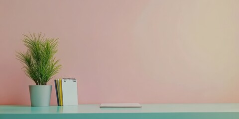 Poster - A desk with a white notebook and a potted plant in a white vase. The plant is placed on the left side of the desk