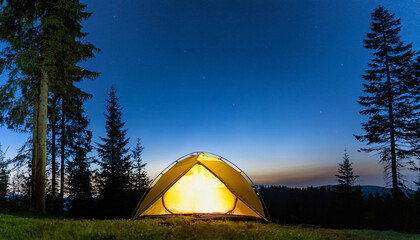 Wall Mural - Camping tent at the bottom of the image in front of a green forest at dusk at the top of the image, space for copy