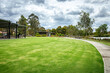 © Doublelee - A well-maintained park featuring a green lawn, a paved walking path, trees, and a covered seating area, a barbecue facility. Taylors Lakes, Melbourne, Australia. Community recreational space.