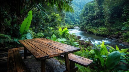 Poster - A wooden table by a river in the jungle, surrounded by vibrant foliage and nature, offering a calm and earthy vibe in a tropical setting