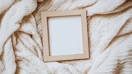 Poster - A blank wooden frame on a soft, fluffy white blanket background, perfect for cozy and intimate branding or message layouts.